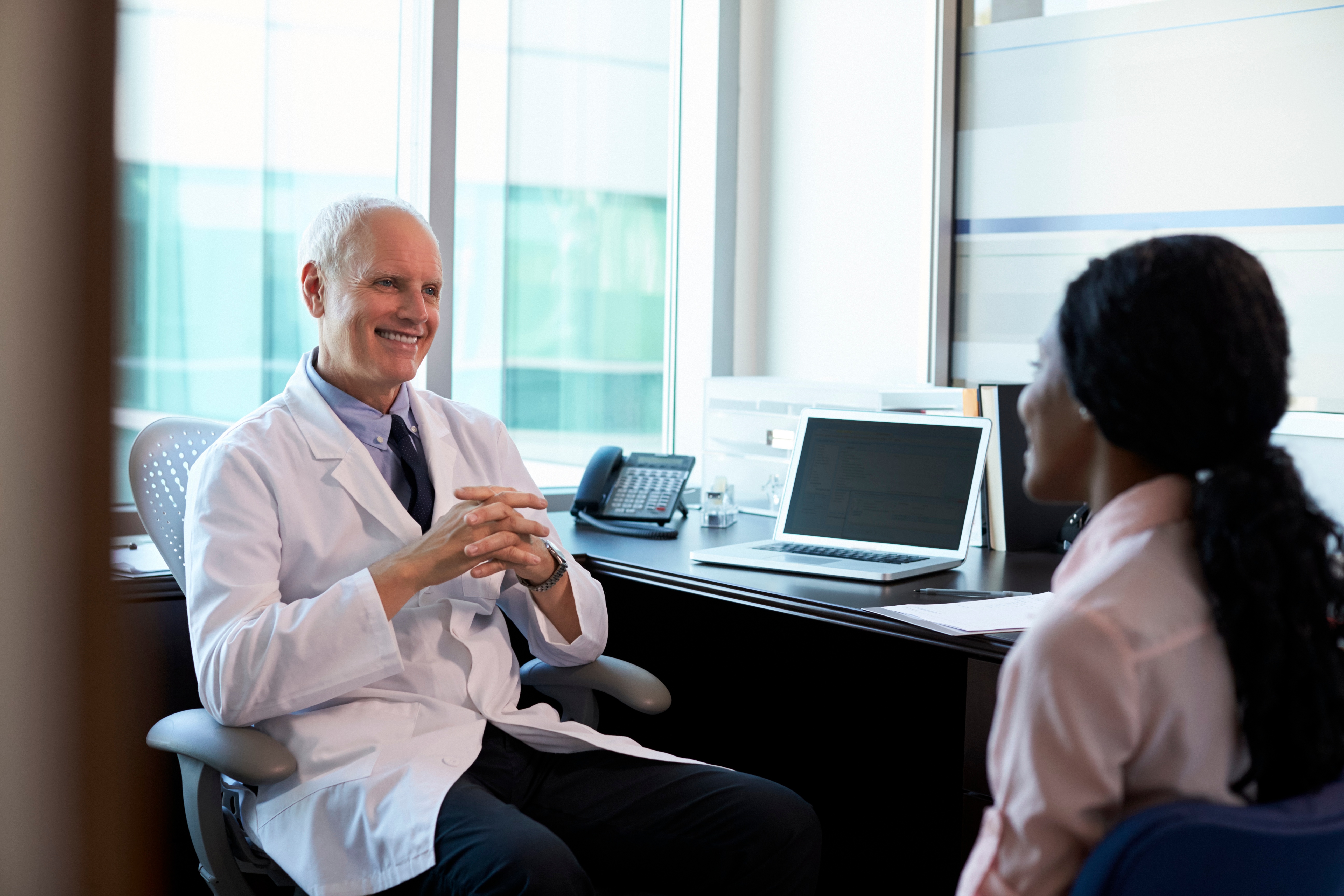 doctor-in-consultation-with-female-patient-PLZRUWN